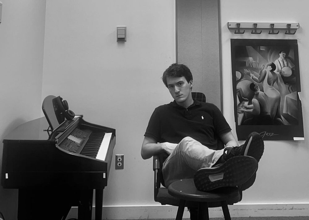 Alex Perez Jr. at Middlebury College, September 2025, seated beside a piano